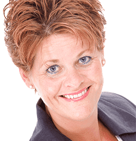 Lachende persoon met kort, lichtbruin haar, gekleed in een donker jasje over een wit shirt, tegen een witte achtergrond.